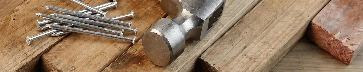 Hammer and nails on hardwood flooring boards in Las Vegas, NV